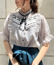 Blouse with brooch